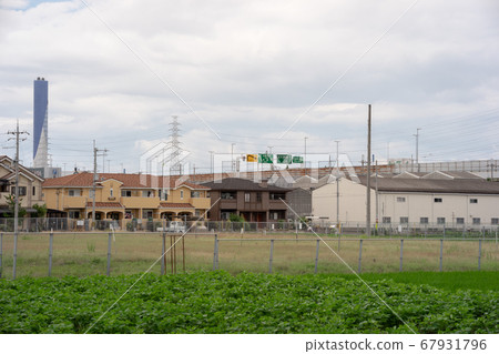 Residential area and fields near Hanshin Expressway Miyake Interchange and chimney of cleaning plant 67931796