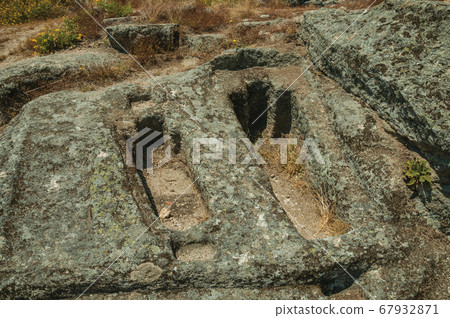 Ancient tombs for child and adult carved in stone 67932871