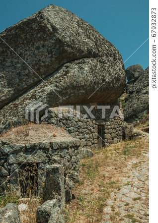 Rustic houses with stone wall inside big rock at Monsanto Rustic houses with stone wall inside big rock at Monsanto 67932873