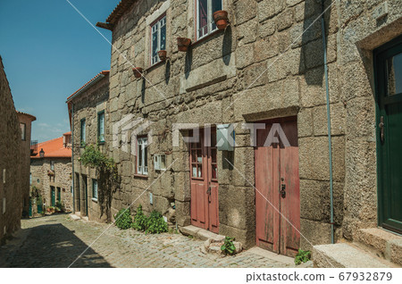 Old stone houses in alley on slope at Monsanto 67932879