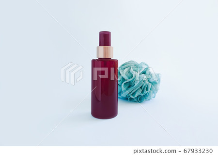Mockup of unbranded brown plastic spray bottle and sponge on a pastel blue background. Natural organic spa cosmetics. Body mist 67933230