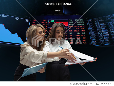 Nervous tensioned investors analyzing crisis stock market with charts on screen on background, falling stock exchange 67933552