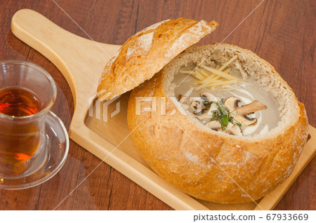 Soup in a bread bowl on the board 67933669