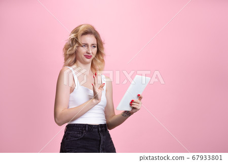 Caucasian young woman's portrait isolated on pink studio background. Beautiful female model. Concept of human emotions, facial expression, sales, ad, youth culture. 67933801