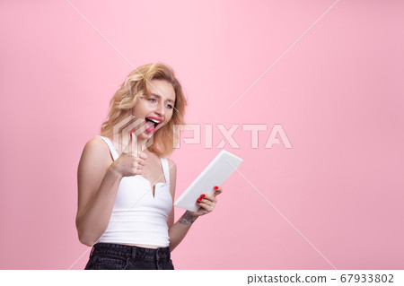 Caucasian young woman's portrait isolated on pink studio background. Beautiful female model. Concept of human emotions, facial expression, sales, ad, youth culture. 67933802