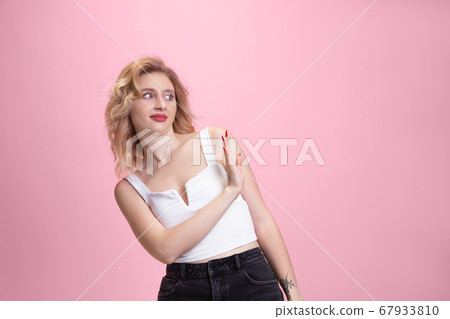 Caucasian young woman's portrait isolated on pink studio background. Beautiful female model. Concept of human emotions, facial expression, sales, ad, youth culture. Caucasian young woman's portrait isolated on pink studio background. Beautiful female model. Concept of human emotions, facial expression, sales, ad, youth culture. 67933810