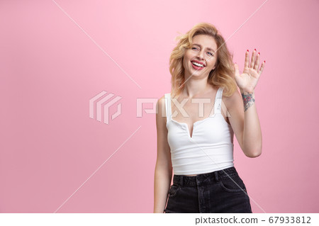 Caucasian young woman's portrait isolated on pink studio background. Beautiful female model. Concept of human emotions, facial expression, sales, ad, youth culture. Caucasian young woman's portrait isolated on pink studio background. Beautiful female model. Concept of human emotions, facial expression, sales, ad, youth culture. 67933812