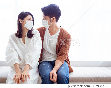 Young asian woman and man wearing Surgical mask to Young asian woman and man wearing Surgical mask to 67934480