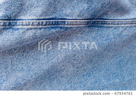 Blue vintage denim. The fabric is light blue. Background, top view. Blue vintage denim. The fabric is light blue. Background, top view. 67934781