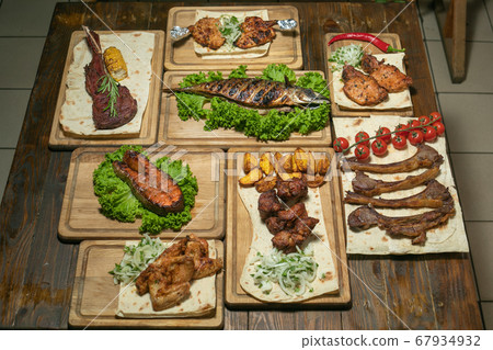 Kebab set and grilled mackerel salmon on wooden boards Kebab set and grilled mackerel salmon on wooden boards 67934932