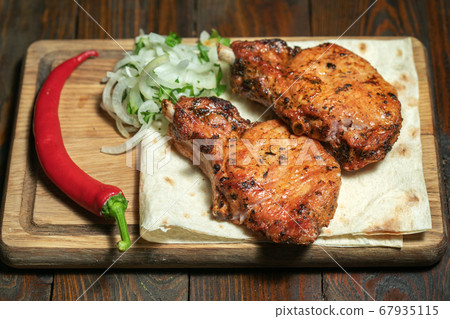 Pork steak with pepper on wooden board Pork steak with pepper on wooden board 67935115