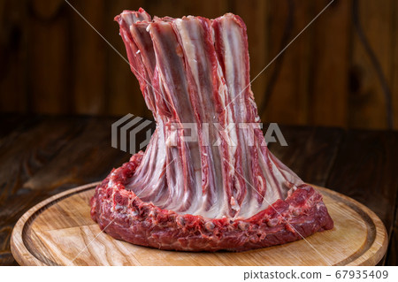 Fresh lamb ribs on the cutting board. Raw meat Fresh lamb ribs on the cutting board. Raw meat 67935409