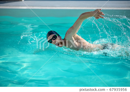 Male excellent swimmer moving in pool water 67935956