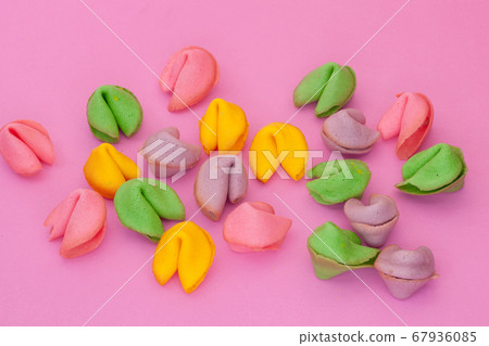 many colored cookies on a pink background 67936085