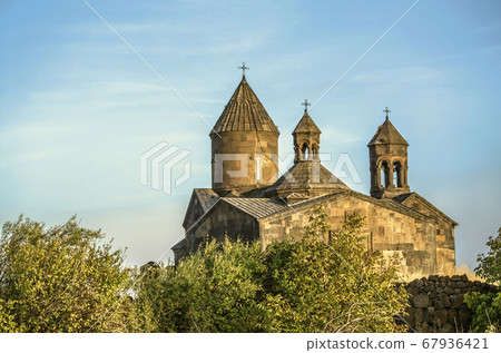 View of Sagmosavank monastery in autumn evening among the orchard located near the town of Ashtarak 67936421