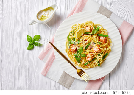 Seafood pasta of salmon and green beans on a plate 67936734
