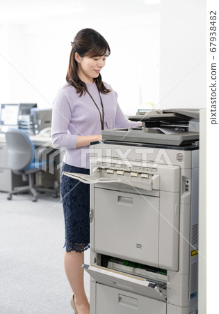 Female employee making a copy 67938482