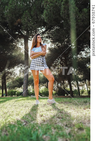 woman in sexy stylish dress posing in the city with standing on the road 67938741