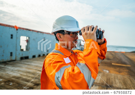 Filipino deck Officer on deck of vessel or ship , wearing PPE personal protective equipment Filipino deck Officer on deck of vessel or ship , wearing PPE personal protective equipment 67938872