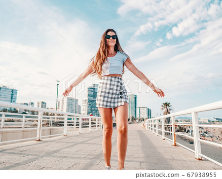 woman in sexy stylish clothes posing in the modern city with skyscrapers on background woman in sexy stylish clothes posing in the modern city with skyscrapers on background 67938955