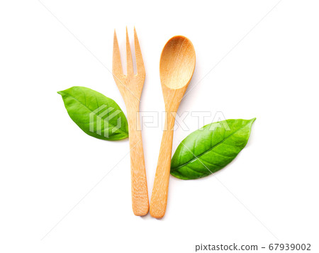 Spoon and fork, Wooden cutlery and green leaves 67939002