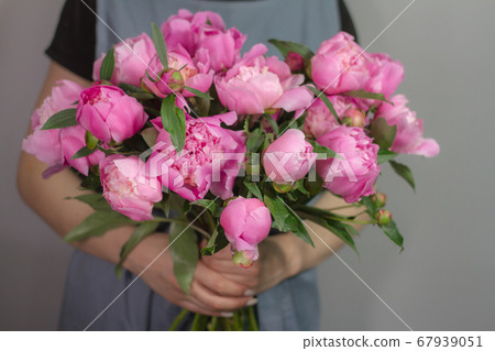 Unrecognizable girl florist with bouquet of pink Unrecognizable girl florist with bouquet of pink 67939051