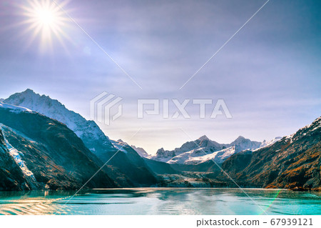 Alaska Cruise Glacier Bay travel landscape view from ship at Johns Hopkins Glacier in Alaska, united states USA. Summer sun flare Alaska Cruise Glacier Bay travel landscape view from ship at Johns Hopkins Glacier in Alaska, united states USA. Summer sun flare 67939121