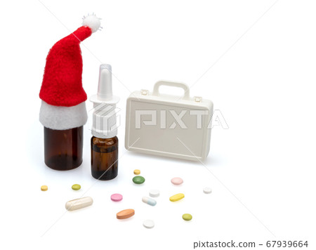 Cold medicine in Santa's hat and pills. 67939664