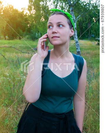Pretty hipster girl speaking on mobile phone. Pretty hipster girl speaking on mobile phone. 67939807