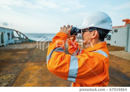 Filipino deck Officer on deck of vessel or ship , wearing PPE personal protective equipment Filipino deck Officer on deck of vessel or ship , wearing PPE personal protective equipment 67939864