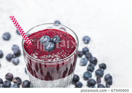 Healthy breakfast or morning snack with chia seeds and blueberries on white stone background, vegetarian food, diet and health concept 67940900