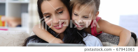 Relaxed smiling woman and happy child Relaxed smiling woman and happy child 67941063