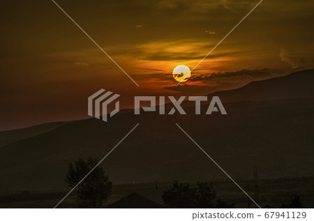 Autumn evening over the mountainous terrain in Armenia with a beautiful sunset of the solar disk in the sky Autumn evening over the mountainous terrain in Armenia with a beautiful sunset of the solar disk in the sky 67941129