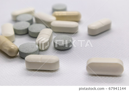 Colored health drug pills on white background Colored health drug pills on white background 67941144