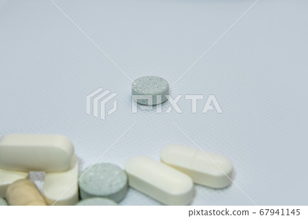 Colored health drug pills on white background 67941145