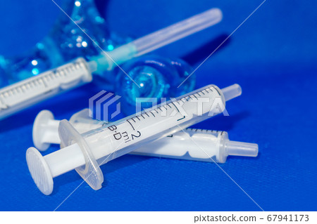 White 2 ml syringes macro on blue vibrant surface White 2 ml syringes macro on blue vibrant surface 67941173