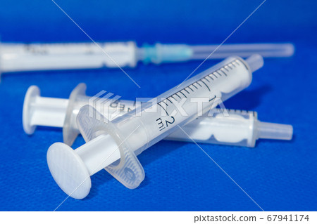 White 2 ml syringes macro on blue vibrant surface White 2 ml syringes macro on blue vibrant surface 67941174