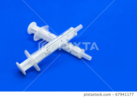White 2 ml syringes macro on blue vibrant surface White 2 ml syringes macro on blue vibrant surface 67941177