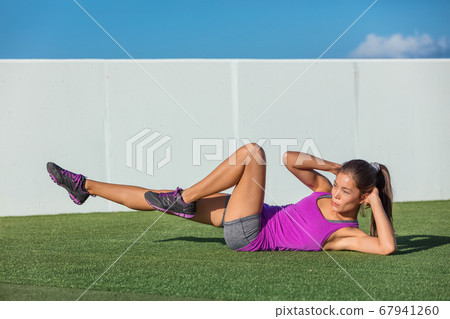 Exercise fitness woman training abs sit up at home. Asian girl doing bicycle crunch workout to train body core. Bodyweight floor exercises. Healthy lifestyle 67941260