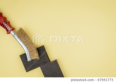 Construction tool on a yellow background.Metal Construction tool on a yellow background.Metal 67941773
