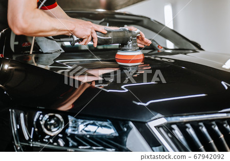Professional detailing a car in car studio, hands with orbital polisher, scratching remover, vehicle care concept Professional detailing a car in car studio, hands with orbital polisher, scratching remover, vehicle care concept 67942092