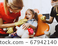 Happy little girl during dental check up 67942140