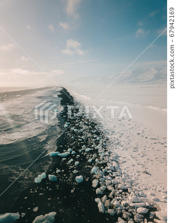 Ice rock with black sand beach at Jokulsarlon beach. Diamond beach in Iceland 67942169