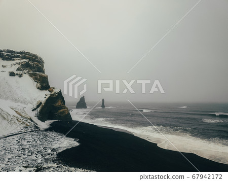 The black sand beach of Reynisfjara and the mount Reynisfjall 67942172