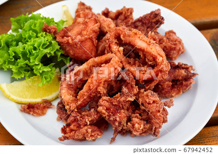 A plate full of fried squid in batter 67942452