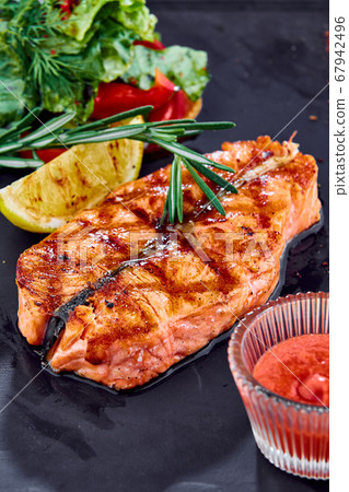 cooked salmon steak on a black stone plateau cooked salmon steak on a black stone plateau 67942496