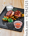 rustic plate with bacon medallions and potatoes 67942525