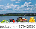 A close up of burger in front of a body of water 67942530