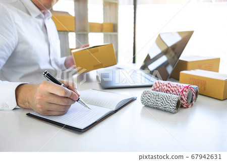 Young business owner work at home receive order Young business owner work at home receive order 67942631