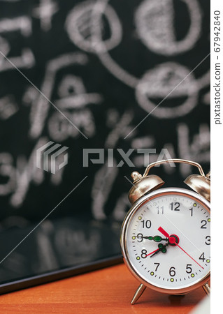 back to school concept, alarm clock on school board background, university back to school concept, alarm clock on school board background, university 67942840
